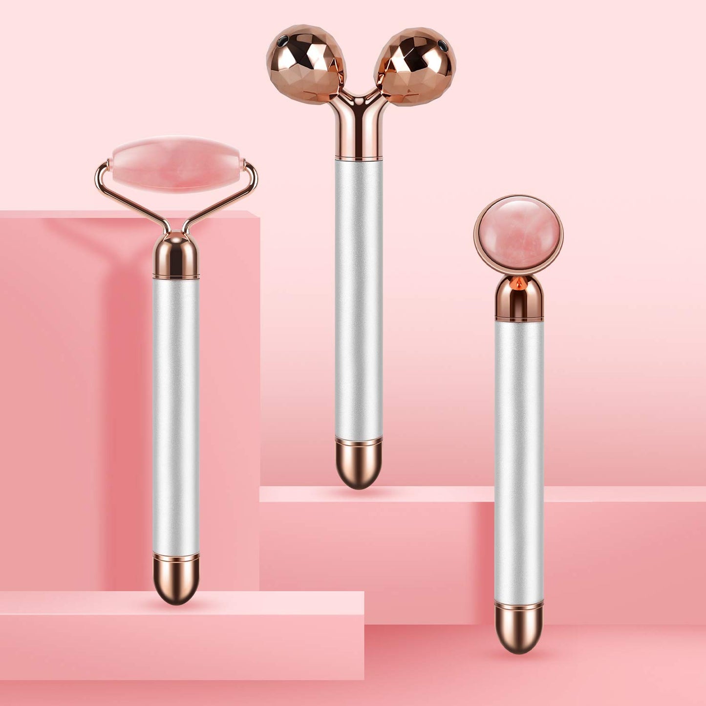 Vibrating Jade Face Massager trio featuring natural jade and ABS handles on a soft pink background.